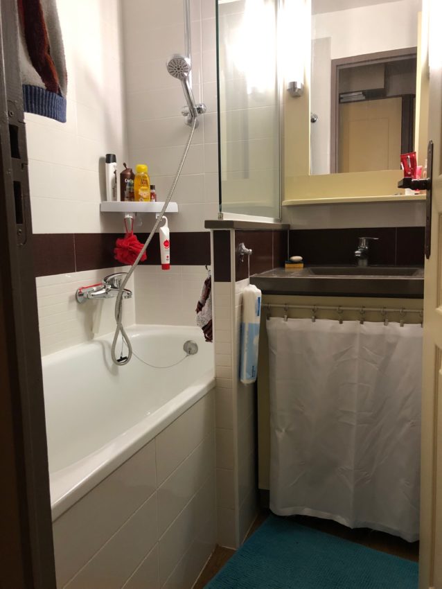 La salle de bain avec sa baignoire douche et son meuble vasque